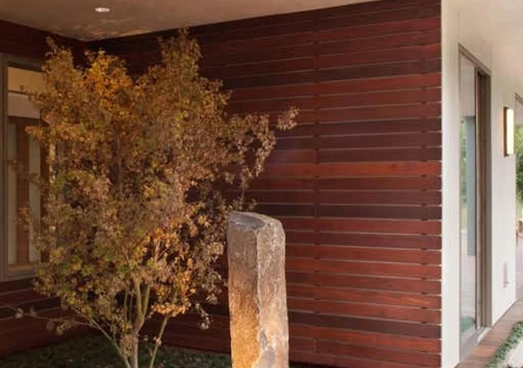 Landscaped entrance courtyard with timber screen and planting